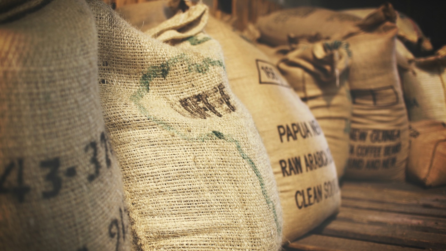 Jute sacks of green coffee in a warehouse