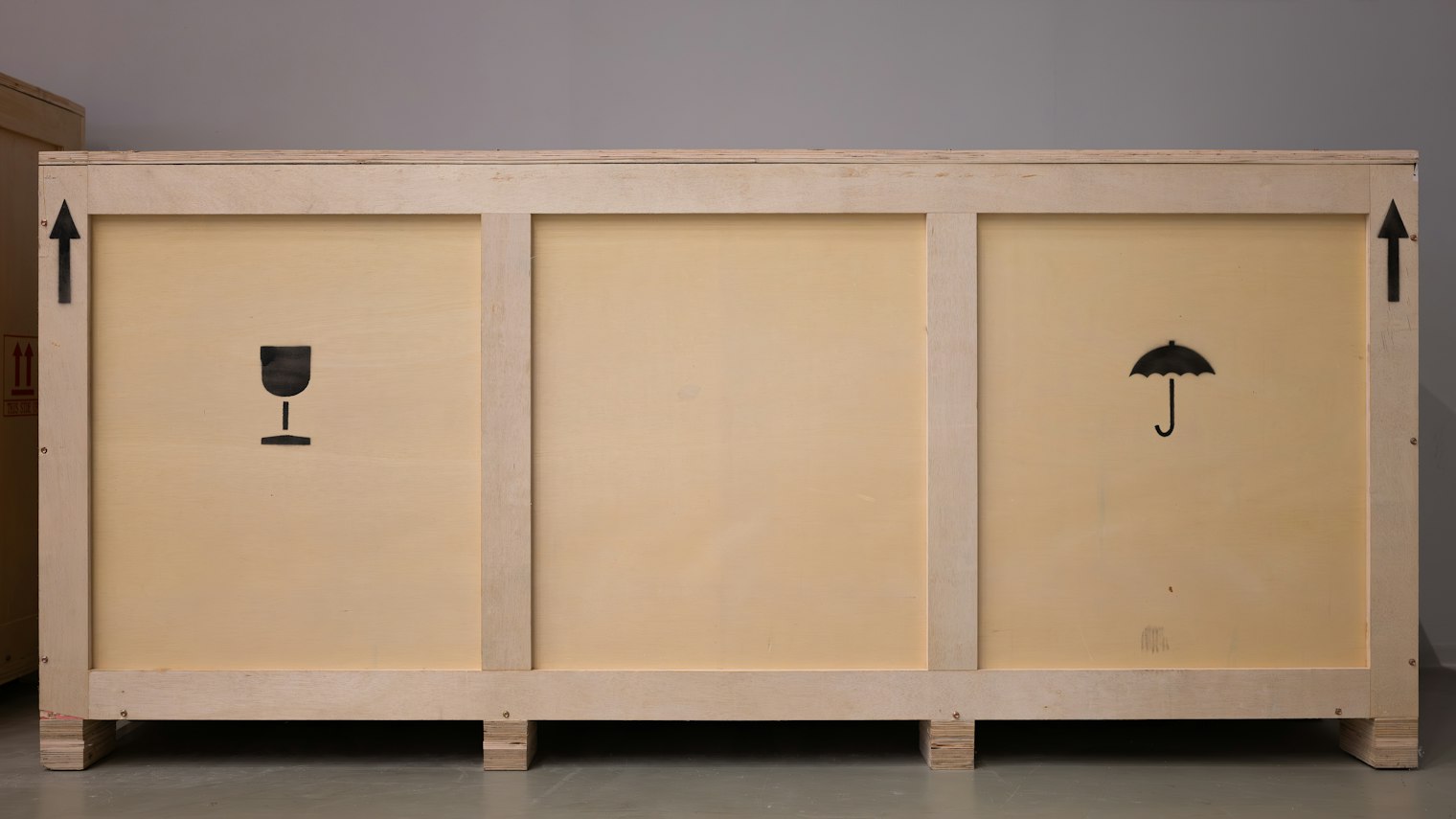 Large wooden crate with printed shipping symbols